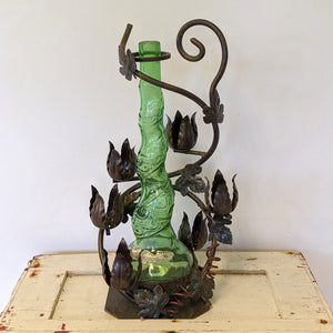 metal wine bottle holder with flowers and green vintage wine bottle/ vase