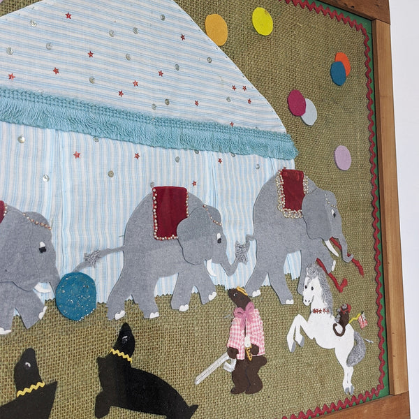 Circus elephants with tent behind them