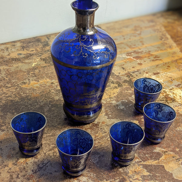 Blue decanter set with silver inlay designs
